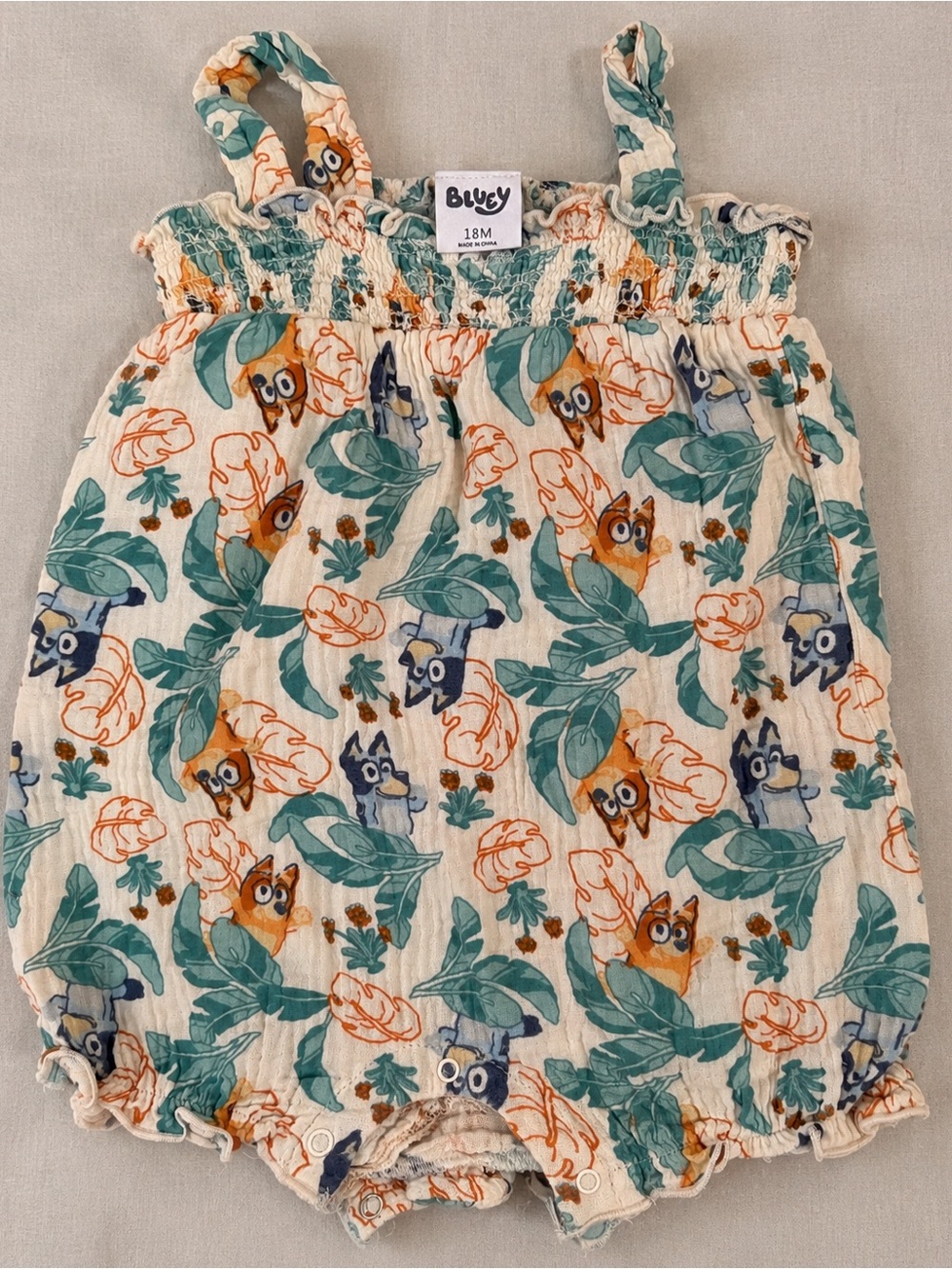 Bluey Toddler One-Piece Bodysuit in Cream with Teal and Orange Print